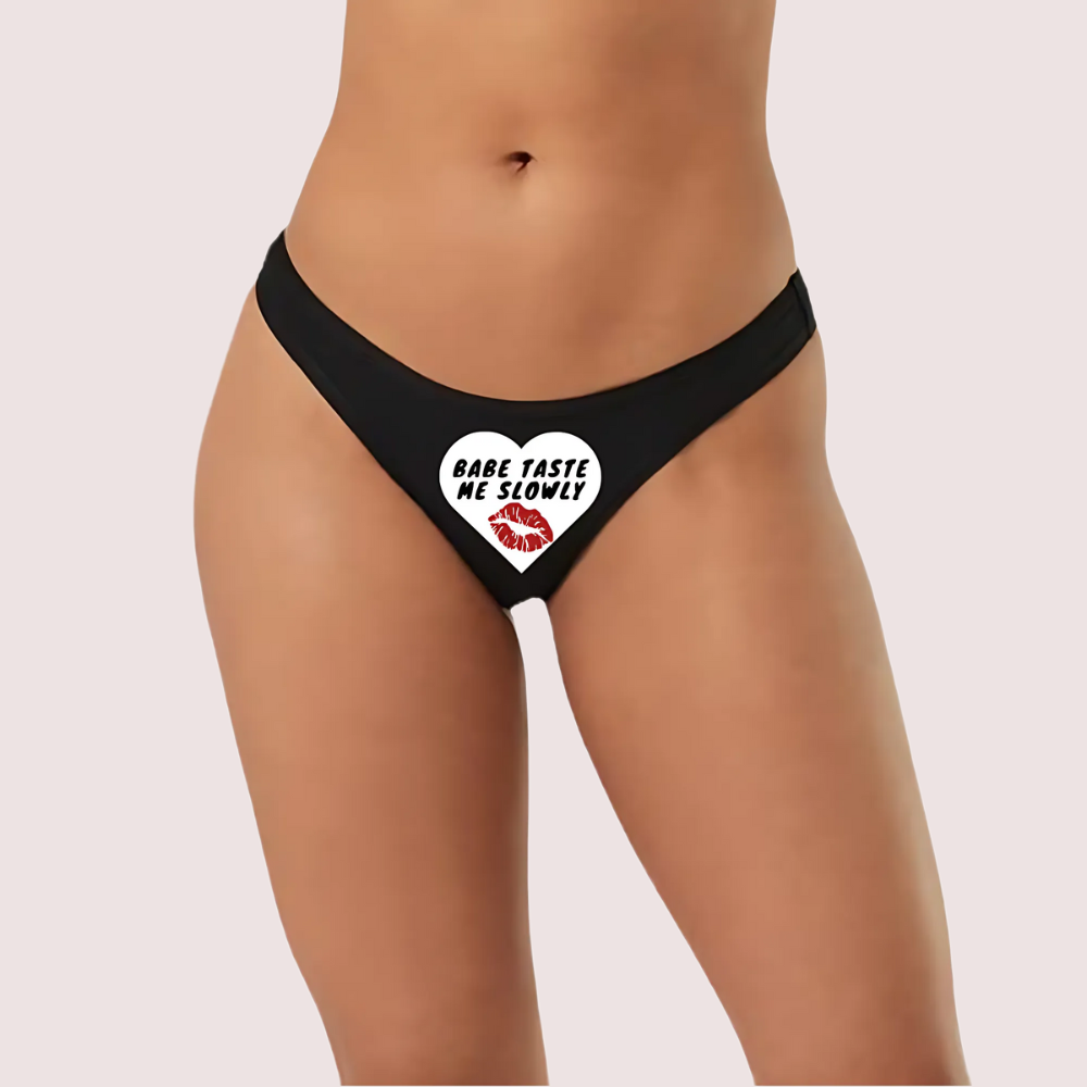 Black thong with a heart design and 'BABE TASTE ME SLOWLY' text. Naughty Quotes Printed Panties.
Beb's Secret Message Naughty Panty