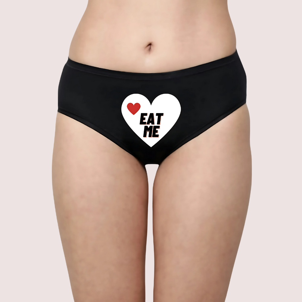 Black underwear with a heart design and 'EAT ME' text. Naughty Quotes Printed Panties.
Eat Me Printed Hipster Panty Gift Pack.